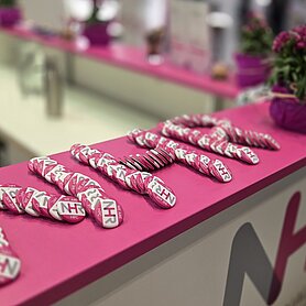 The NHR marketing buttons layed out in the shape of NHR logo on the counter of NHR stand.